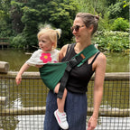 Woman holding a child in a sling