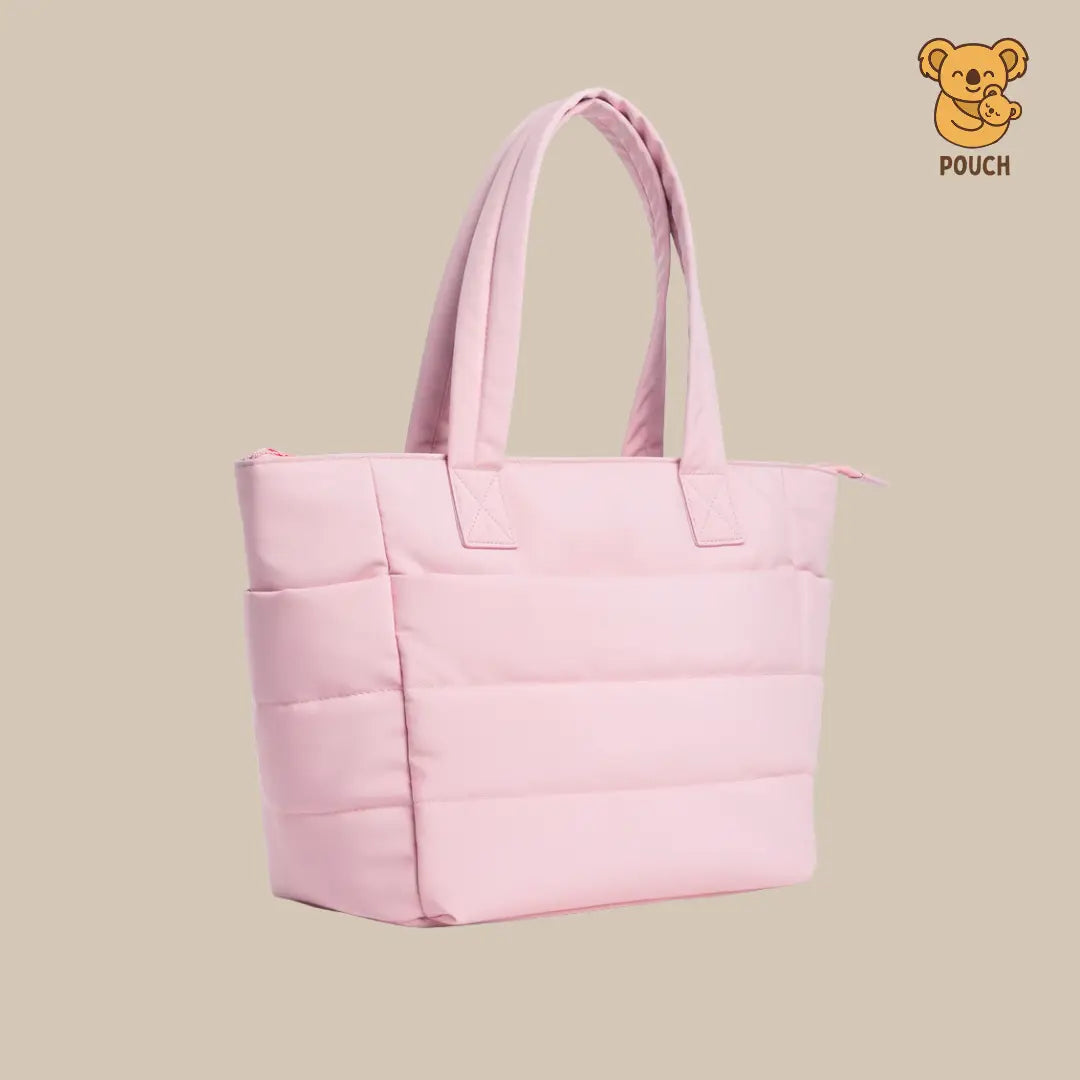 Pink quilted tote bag on a beige background with a brand logo in the corner.