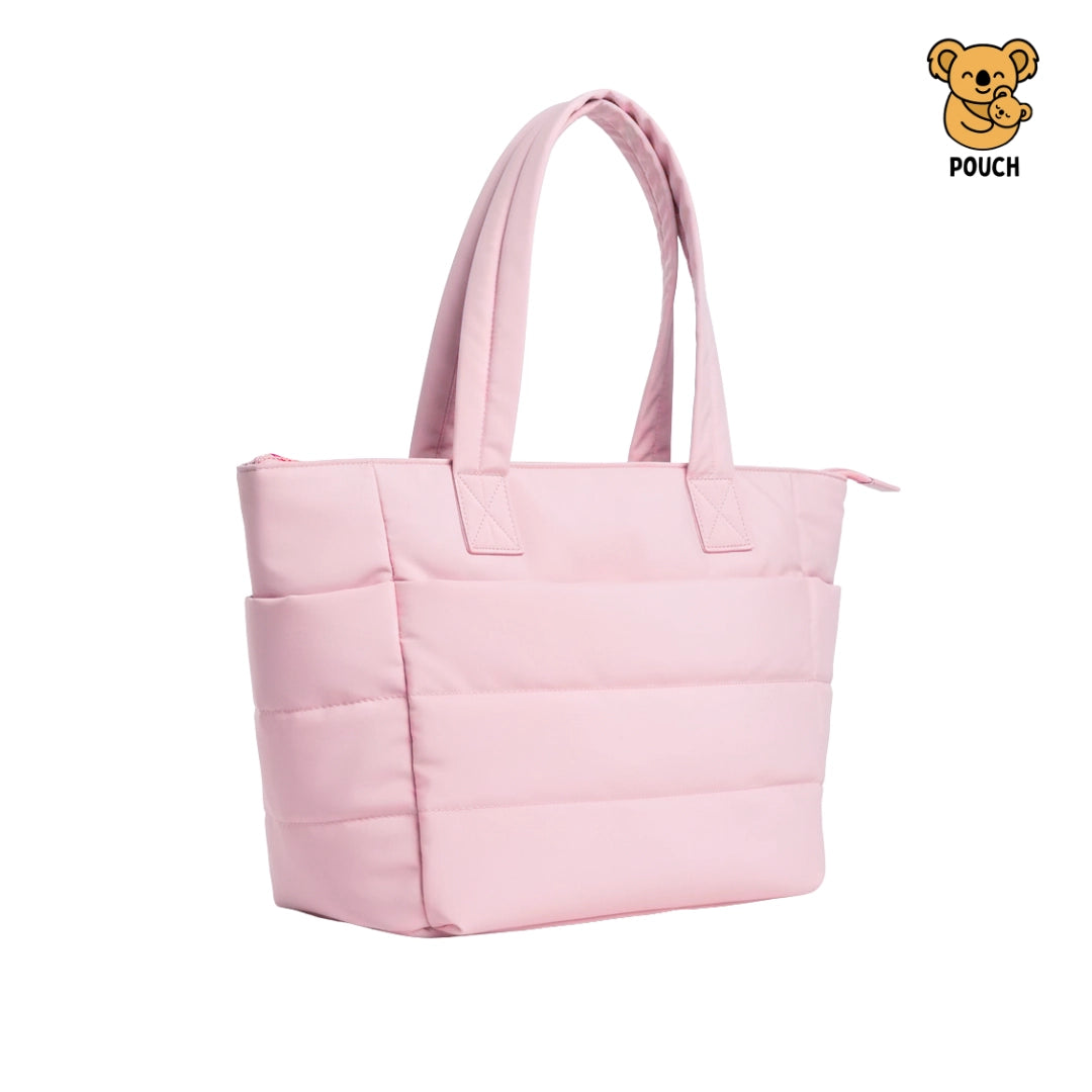 Pink quilted tote bag on a beige background with a brand logo in the corner.